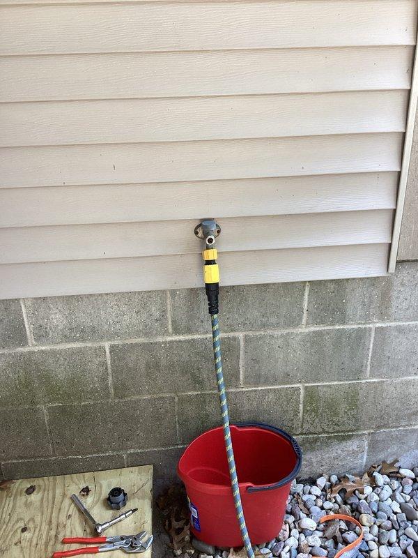 Responded to return service call for exterior hose bib that was previously repaired but had resumed leaking. Upon arrival, inspected the outdoor spigot mounted on the building's vinyl siding above the concrete block foundation. Identified failed seal or valve component causing water leakage. Removed and replaced faulty internal parts of the hose bib assembly. Tested the spigot under full water pressure to verify complete repair and confirm no further leaking. Repair completed successfully with proper function restored to the outdoor faucet.