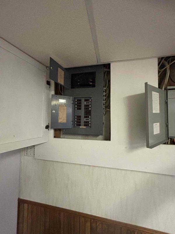Conducted comprehensive electrical assessment for main service panel upgrade with integrated whole-house surge protection and generator transfer switch installation. Evaluated existing electrical infrastructure including current panel configuration, circuit capacity, and available space for new equipment installation. Documented existing dual-panel setup with multiple circuit breakers and incoming service conductors to determine compatibility requirements for upgraded components. Provided detailed estimate for upgrading electrical service box to accommodate modern surge protection system and manual or automatic transfer switch to enable seamless generator backup power integration during utility outages.