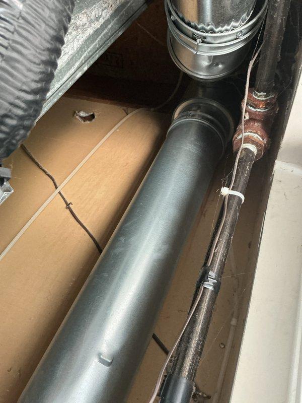 Responded to service call for water heater leaking from bottom. Upon inspection, found 10-year-old residential water heater with visible water accumulation at base of unit. Assessed condition of water heater and surrounding HVAC equipment in mechanical closet. Documented equipment setup including water heater, air handler unit, refrigerant lines, and ductwork configuration. Due to age of unit and location of leak at bottom of tank, determined water heater requires replacement as tank leaks are not repairable. Photographed installation area and equipment for replacement planning purposes.