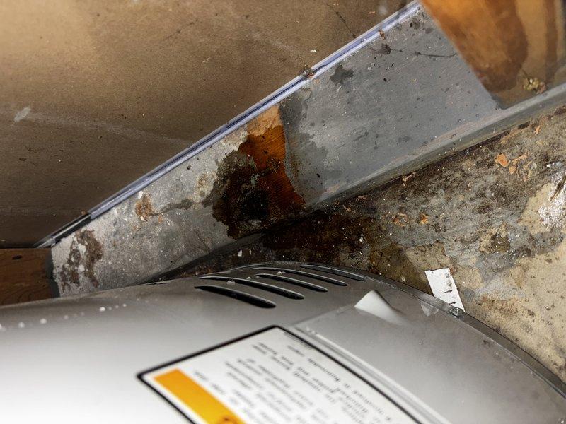 Responded to water leak on 9-year-old Bradford White water heater. Identified failed temperature and pressure relief valve as source of leak, evidenced by corrosion and water staining on surrounding concrete surfaces. Removed defective T&P relief valve and replaced with new brass valve, restoring proper operation and eliminating active leak.