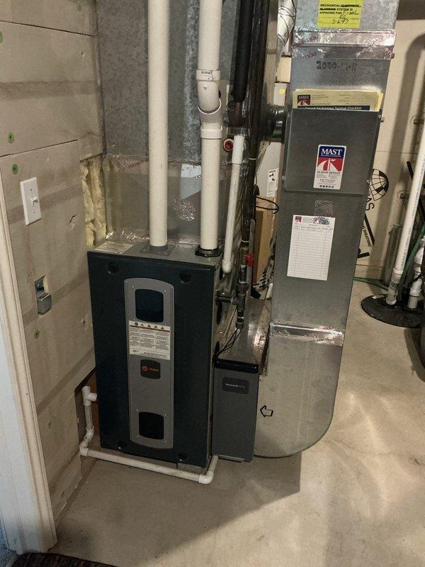 Completed estimate for air conditioning system replacement at residential property experiencing inadequate cooling performance during peak temperature conditions. Evaluated existing HVAC equipment in basement mechanical room, including current furnace/air handler and associated ductwork system. Documented equipment specifications, assessed system capacity limitations, and photographed existing installation to provide comprehensive replacement options for either traditional air conditioning unit or heat pump system to address cooling deficiency issues.