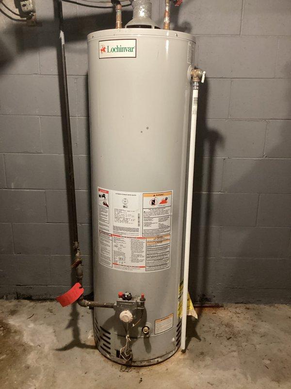 Provided estimate for replacement of existing Lochinvar tank-style water heater with new standard 50-gallon unit at single-family residence. Inspected current installation in basement utility room, documented existing piping configuration including copper water lines and gas connections, and photographed unit specifications and mechanical room layout. Customer approved quote for new Bradford White water heater installation.