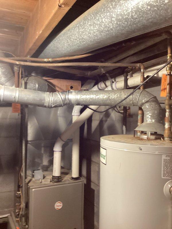 Provided estimate for replacement of existing Lochinvar tank-style water heater with new standard 50-gallon unit at single-family residence. Inspected current installation in basement utility room, documented existing piping configuration including copper water lines and gas connections, and photographed unit specifications and mechanical room layout. Customer approved quote for new Bradford White water heater installation.