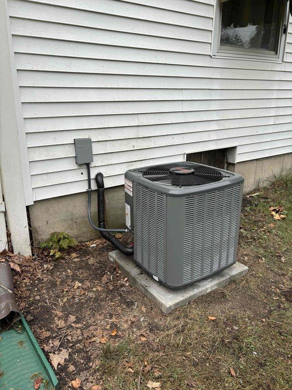 Completed full HVAC system replacement including outdoor condensing unit and indoor furnace assembly. Installed new gray cabinet furnace with proper PVC intake and exhaust venting configuration in mechanical room. Connected metallic supply ductwork and copper refrigerant lines with isolation valve. Mounted outdoor condensing unit on existing concrete pad with proper clearances from structure. Installed electrical disconnect box on exterior wall and ran conduit from house to unit. Verified all refrigerant line connections, electrical wiring, and condensate drainage. System tested and operational upon completion.