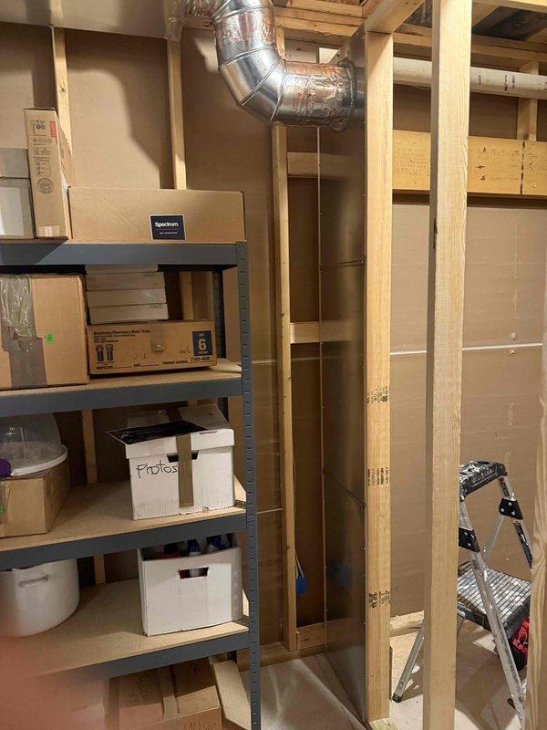 Installed new ceiling-mounted supply register and low wall return air grille in basement room undergoing finishing work. Extended flexible ductwork through exposed framing to accommodate new register locations, connecting to existing HVAC system. Permit obtained prior to installation per local building code requirements.