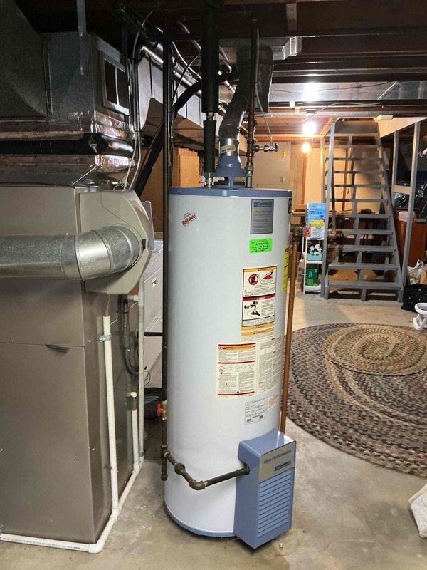 Conducted on-site evaluation for water heater replacement and assessed feasibility of tankless water heater installation. Inspected existing 40-gallon Sears natural gas water heater (Model 153.331444, 40,000 BTU input, manufactured April 2008) located in basement utility area alongside HVAC equipment. Documented current installation configuration including venting, gas supply connections, and spatial constraints, then provided comprehensive estimate for replacement options including both traditional tank and tankless water heater systems.