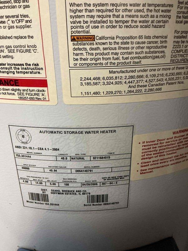 Conducted on-site evaluation for water heater replacement and assessed feasibility of tankless water heater installation. Inspected existing 40-gallon Sears natural gas water heater (Model 153.331444, 40,000 BTU input, manufactured April 2008) located in basement utility area alongside HVAC equipment. Documented current installation configuration including venting, gas supply connections, and spatial constraints, then provided comprehensive estimate for replacement options including both traditional tank and tankless water heater systems.
