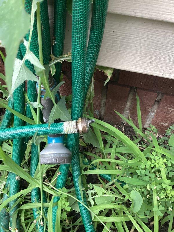 Responded to service call for exterior spigot inspection. Evaluated multiple outdoor hose bibs and water supply connections mounted on building exterior, including brass fittings with temporary wrapping material. Documented condition of plumbing fixtures, associated piping, and connections for maintenance records. Noted vegetation growth around foundation area near water supply lines that may require future access considerations.