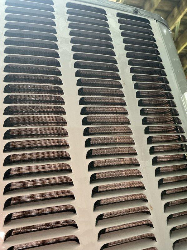 Completed annual cooling system tune-up and inspection on 2017 cooling unit under EnergiAir warranty coverage. Performed comprehensive maintenance including inspection of evaporator coil and ventilation components, documenting condition with photos showing accumulated dust and debris on air vent grilles and copper coil fins. All system components operating within normal parameters upon completion of preventive maintenance service.