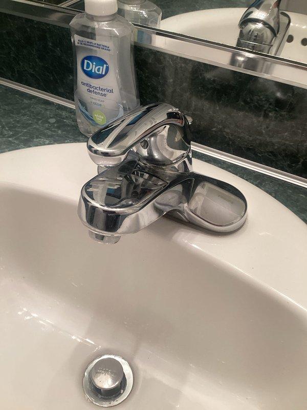 Completed plumbing estimate for residential property addressing multiple concerns. Assessed primary bathroom faucet requiring repair, noting chrome single-handle fixture with worn finish showing signs of age and use. Evaluated water pressure issues at bathroom sink to determine feasibility of increasing flow rate. Provided estimate for installation of garbage disposal unit at basement bar sink location. Documented existing plumbing fixtures and conditions through photographic assessment to support project scope and pricing recommendations.