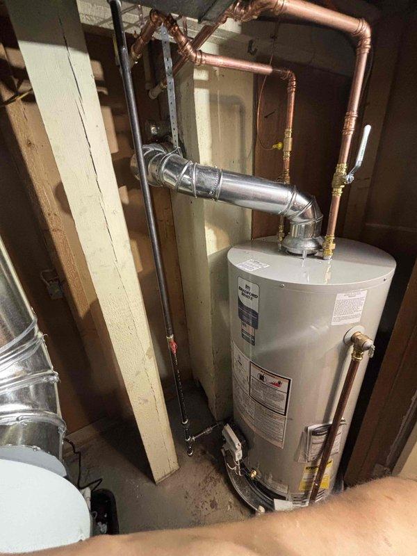 Completed full HVAC system installation including furnace, air conditioning unit, and water heater at residential property. Installed outdoor AC condenser unit on concrete pad with proper electrical disconnect, refrigerant line routing through foundation, and connection to indoor components. Installed new water heater in basement utility area with copper supply piping, pressure relief valve, metallic exhaust venting, and proper wall mounting per manufacturer specifications.