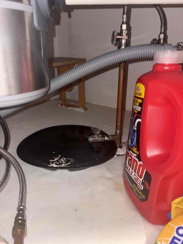 Responded to no water call where homeowner had shut off main water supply due to active leak. Upon arrival, performed comprehensive inspection of plumbing system to locate source of water loss. Examined under-sink plumbing configuration including garbage disposal unit, PVC drainage pipes, and flexible supply lines. Inspected water heater area and associated copper piping connections. Identified leak location and assessed extent of damage. Utilized diagnostic equipment to verify system integrity. Documented conditions with photos showing affected areas including disposal installation, supply lines, and water heater connections with drain pan. Provided customer with findings and recommendations for necessary repairs to restore water service safely.