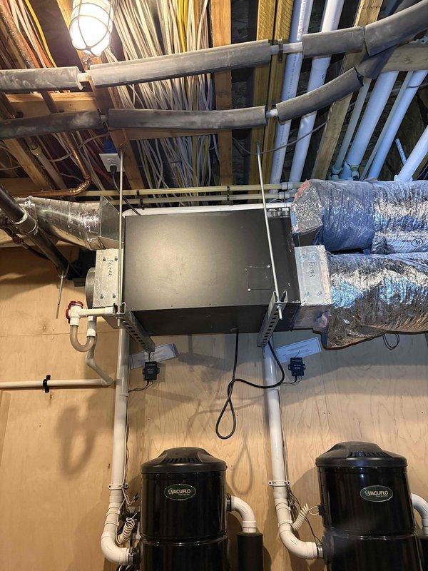 Responded to service call for 7-year-old Fujitsu mini-split system not maintaining set temperature. Customer reported thermostat set to 74°F cooling mode but home temperature rising to 86°F instead of cooling properly. Inspected attic-mounted air handler unit and associated ductwork system. Evaluated system operation, thermostat communication, and temperature sensor functionality. Verified proper electrical connections, refrigerant lines, and duct insulation integrity. Documented equipment installation including air handler, insulated ductwork, and auxiliary HVAC components. Captured photos of mechanical space showing complete system layout for service records.