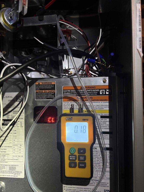 # CP-Cooling Problem Resolution

Responded to no airflow complaint with unit frozen over. Upon arrival, found evaporator coil completely iced, restricting all airflow to living space. Verified blower motor operation and measured amp draw at 0.67A and 0.10A under different conditions using digital meter, confirming motor functionality within acceptable range. 

Identified frozen coil as primary issue preventing air circulation. Shut down system to allow complete defrost of evaporator coil. Inspected air filter, ductwork accessibility, and blower compartment for restrictions or maintenance concerns. Monitored system components during diagnostic process to determine root cause of freeze condition. Documented equipment readings and conditions with photos for service records. Unit is 0 years old Carrier model with warranty expiration July 2027. Advised on proper system operation and maintenance to prevent future freeze-ups.
