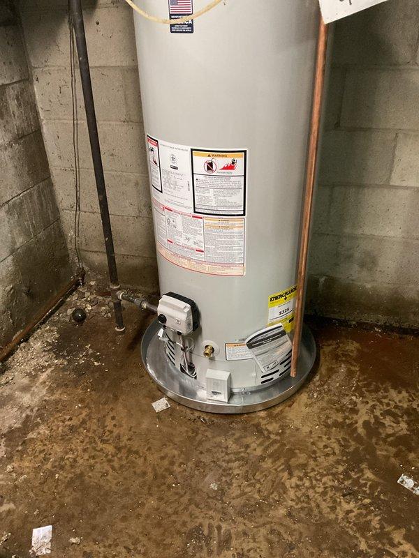 # Water Heater Installation

Successfully completed installation of a 50-gallon natural gas Bradford White water heater in basement utility area. Removed existing failed unit and installed new water heater with proper venting and gas connections per manufacturer specifications and local code requirements.

## Work Performed

Connected incoming cold water supply line with shutoff valve and installed temperature and pressure relief valve with proper discharge piping termination. Installed hot water outlet piping using copper materials with appropriate fittings and unions for future serviceability. Integrated existing recirculation pump system into new installation to maintain hot water circulation throughout the residence.

Verified all gas connections for proper seal and conducted leak test on gas line and fittings. Ensured proper clearances from combustible materials and adequate combustion air supply for safe operation. Connected flue vent system to existing chimney with proper draft 