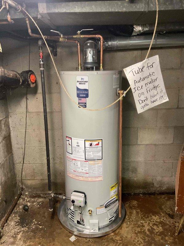 # Water Heater Installation

Successfully completed installation of a 50-gallon natural gas Bradford White water heater in basement utility area. Removed existing failed unit and installed new water heater with proper venting and gas connections per manufacturer specifications and local code requirements.

## Work Performed

Connected incoming cold water supply line with shutoff valve and installed temperature and pressure relief valve with proper discharge piping termination. Installed hot water outlet piping using copper materials with appropriate fittings and unions for future serviceability. Integrated existing recirculation pump system into new installation to maintain hot water circulation throughout the residence.

Verified all gas connections for proper seal and conducted leak test on gas line and fittings. Ensured proper clearances from combustible materials and adequate combustion air supply for safe operation. Connected flue vent system to existing chimney with proper draft 