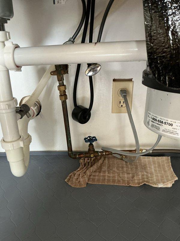 Completed installation of customer-supplied kitchen faucet on double-basin stainless steel sink. Removed existing faucet, installed new high-arc pull-down spray faucet with brushed metal finish, connected hot and cold water supply lines to existing copper piping with brass fittings and shut-off valves, tested for leaks, and verified proper operation of spray head functionality.