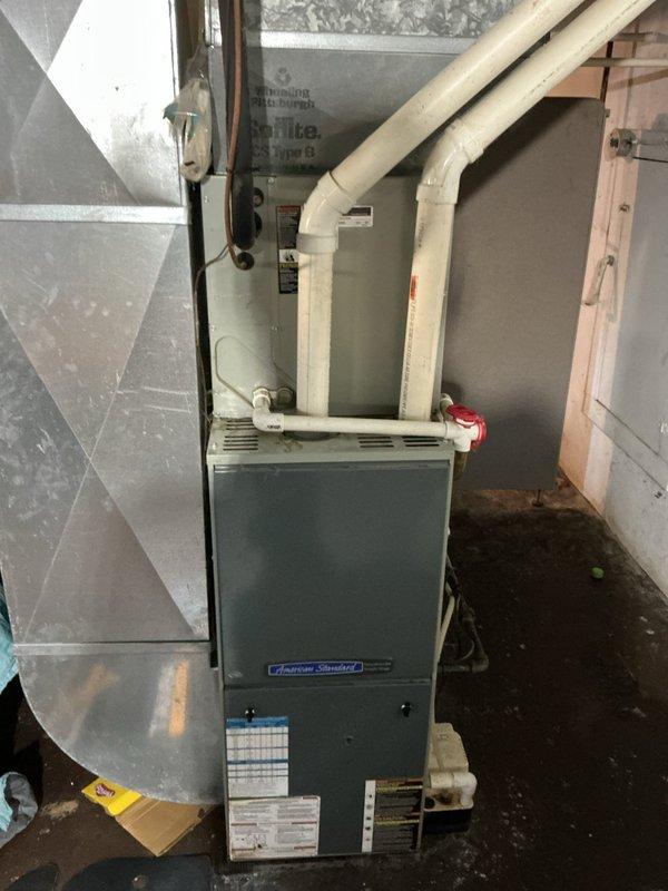 Responded to insufficient cooling complaint on 16-year-old Ameristar 7B0023B100A air conditioning system. Upon arrival, confirmed exterior condenser fan motor operational with adequate airflow. Verified indoor filter and return grills were clean and unobstructed. 

Inspected outdoor condensing unit and discovered significant debris accumulation including spider webs, organic material, and dirt buildup throughout cabinet interior and on condenser coil fins. This contamination was restricting proper heat transfer and reducing system efficiency. Cleaned condenser coil and removed debris from unit interior to restore proper airflow across heat exchange surfaces.

Performed system diagnostics and measured refrigerant pressures. Identified low refrigerant charge in HCFC-22 system. Added 3 pounds 6 ounces of R-22 refrigerant to bring system to manufacturer specifications. Monitored system operation following recharge to verify proper cooling performance restoration.

Documented equipment cond