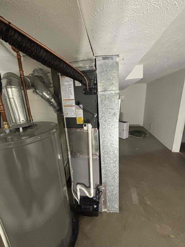 Successfully completed add-on central air conditioning system installation with coordinated electrical service upgrade to 100A. Installed new indoor air handler unit in basement mechanical room with vertical galvanized ductwork, integrated with existing water heater and utility infrastructure. Mounted outdoor condensing unit on concrete pad against exterior wall with proper refrigerant line connections and electrical disconnect. Coordinated utility power disconnect and reconnection with service provider to facilitate safe electrical panel upgrade work. Obtained electrical permit and scheduled final inspection with local building department. System was fully charged, tested with diagnostic equipment, and verified operational with proper pressure readings on both high and low side service ports. All work completed per manufacturer specifications and local electrical code requirements.