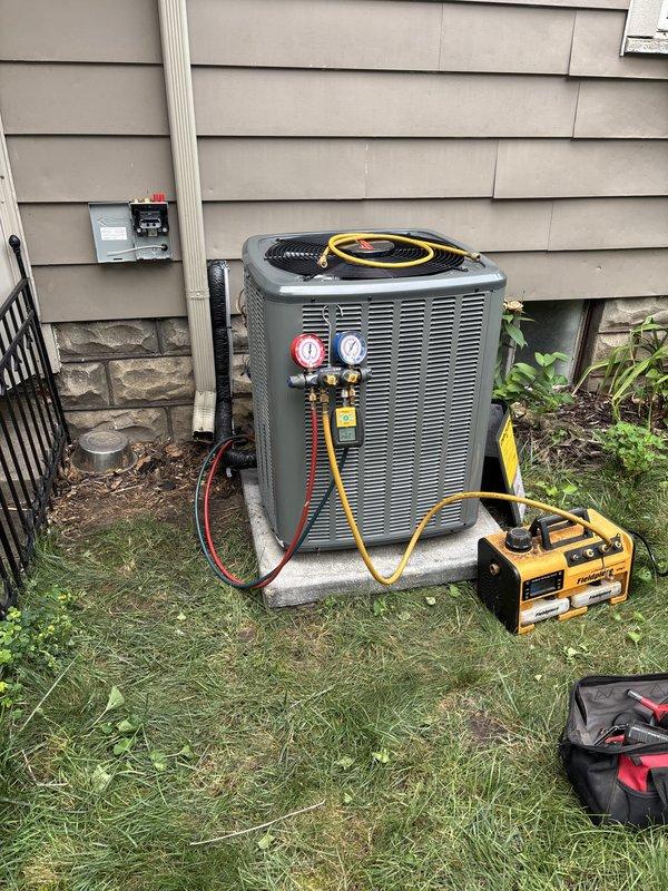 Successfully completed add-on central air conditioning system installation with coordinated electrical service upgrade to 100A. Installed new indoor air handler unit in basement mechanical room with vertical galvanized ductwork, integrated with existing water heater and utility infrastructure. Mounted outdoor condensing unit on concrete pad against exterior wall with proper refrigerant line connections and electrical disconnect. Coordinated utility power disconnect and reconnection with service provider to facilitate safe electrical panel upgrade work. Obtained electrical permit and scheduled final inspection with local building department. System was fully charged, tested with diagnostic equipment, and verified operational with proper pressure readings on both high and low side service ports. All work completed per manufacturer specifications and local electrical code requirements.