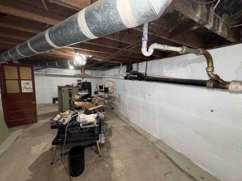 Conducted comprehensive plumbing assessment for residential property experiencing weak water pressure throughout the house, with specific evaluation of two bathroom sinks and kitchen fixtures. Provided estimate for toilet installation in basement area and addressed additional plumbing concerns in the lower level utility space. Documented existing mechanical systems, exposed piping infrastructure including PVC and metal supply lines, and crawl space conditions with vapor barrier present for project planning purposes.