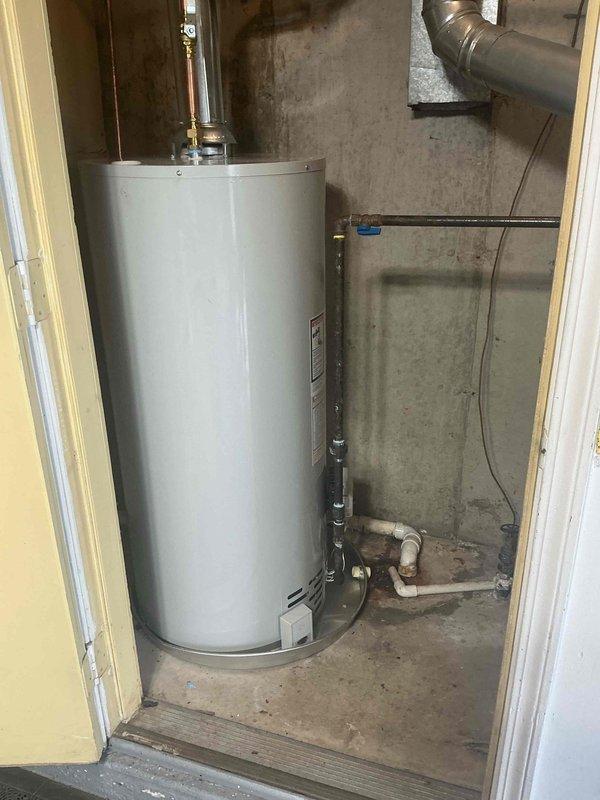 Installed a 40-gallon natural gas water heater with a short configuration in the basement utility room. Replaced the existing shut-off valve and connected all copper supply lines and gas piping to the new unit, ensuring proper pressure relief valve installation and venting through existing ductwork.
