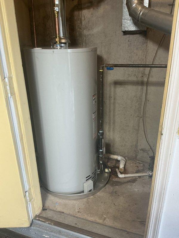Installed a 40-gallon natural gas water heater with a short configuration in the basement utility room. Replaced the existing shut-off valve and connected all copper supply lines and gas piping to the new unit, ensuring proper pressure relief valve installation and venting through existing ductwork.