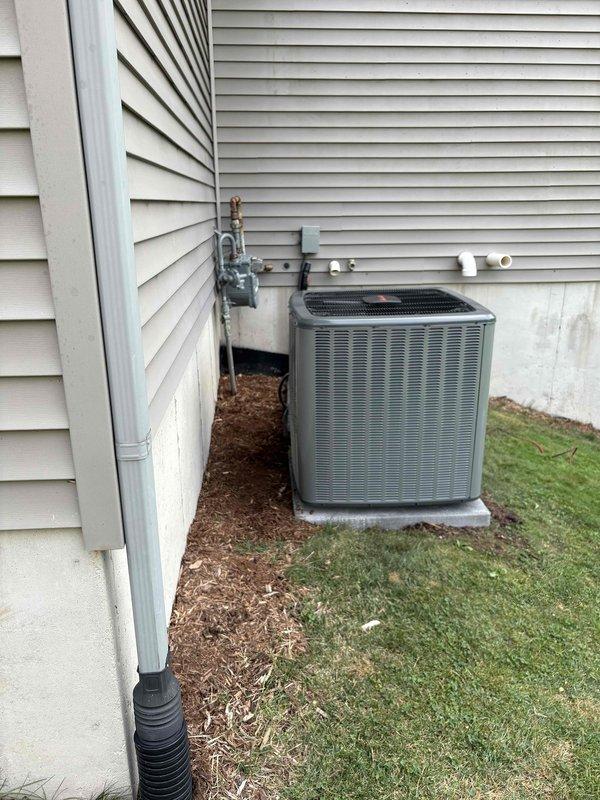 Completed full HVAC system installation including new furnace and air conditioning condenser unit. Installed outdoor AC unit on concrete pad against exterior wall with proper clearances, ran copper refrigerant line set vertically along siding, and connected all electrical service including disconnect box and power whip. Installed PVC condensate drain line from interior equipment through exterior wall termination. Connected gas line to new furnace from existing meter location. Tested all electrical connections, verified proper refrigerant charge and pressures, confirmed condensate drainage, and ensured all safety controls operational. System startup successful with all equipment functioning within manufacturer specifications.