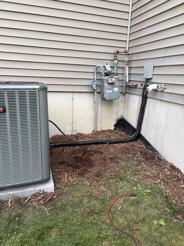 Completed full HVAC system installation including new furnace and air conditioning condenser unit. Installed outdoor AC unit on concrete pad against exterior wall with proper clearances, ran copper refrigerant line set vertically along siding, and connected all electrical service including disconnect box and power whip. Installed PVC condensate drain line from interior equipment through exterior wall termination. Connected gas line to new furnace from existing meter location. Tested all electrical connections, verified proper refrigerant charge and pressures, confirmed condensate drainage, and ensured all safety controls operational. System startup successful with all equipment functioning within manufacturer specifications.