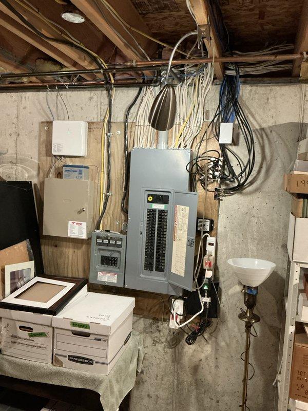 Completed annual air conditioning tune-up and maintenance service on a 12-year-old residential cooling system. Inspected electrical panel and circuit breaker configuration in basement utility area, documented existing electrical infrastructure including main disconnect and circuit distribution, and verified proper electrical supply to HVAC equipment for safe system operation.