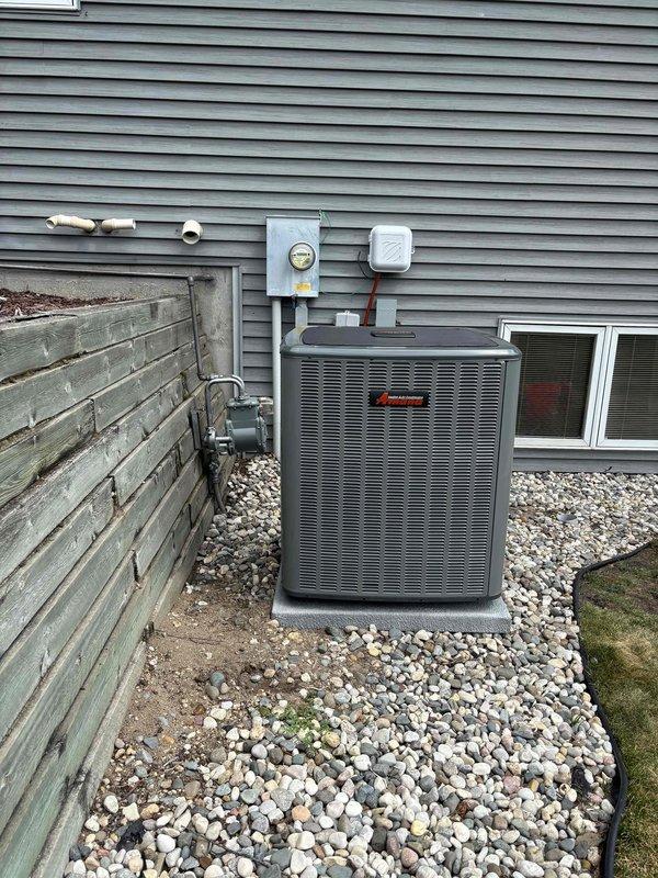 Completed full air conditioning system replacement at residential property. Removed existing HVAC unit and installed new Amana-branded condensing unit on existing concrete pad in side yard gravel bed. Ran new refrigerant lines with proper insulation from outdoor unit through exterior wall penetration to connect with indoor air handler. Verified all electrical connections at outdoor disconnect and metered service. Tested system operation, confirmed proper refrigerant charge, and validated all safety controls functioning correctly.