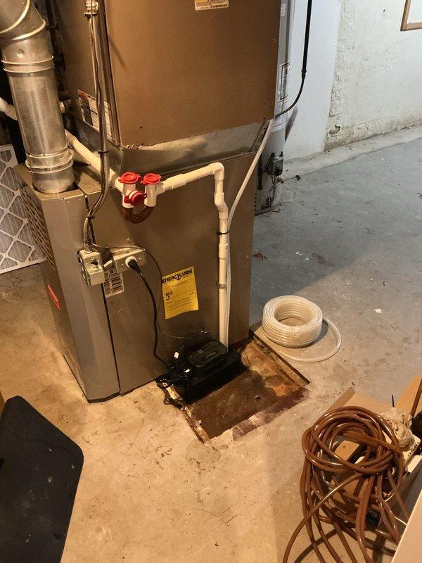 # Cooling System Service Call

Responded to service call for 13-year-old Carrier air conditioning system experiencing inadequate cooling performance with unit running only ten minutes per cycle before shutting down. Upon arrival, performed comprehensive system diagnostic including visual inspection of indoor air handler unit located in basement utility area and evaluation of operating parameters.

Inspected furnace/air handler installation, noting presence of condensate pump system at base of unit with evidence of previous moisture concerns indicated by floor staining around equipment. Verified proper condensate drainage connections and PVC piping configuration with shut-off valves. Examined electrical connections and control wiring for signs of deterioration or loose connections that could cause premature cycling.

Evaluated airflow through system by checking filter condition, ductwork connections, and blower operation. Assessed refrigerant circuit performance through temperature diff