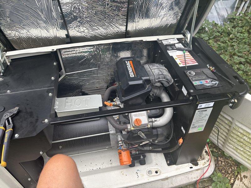 Responded to service call for 8-year-old Generac generator experiencing rough operation, causing flickering lights and air conditioning failure. Upon inspection, discovered oil accumulation in the air filter compartment, indicating potential breather system malfunction or excessive crankcase pressure. Performed diagnostic evaluation of engine components, oil filter assembly, and associated mounting hardware. Inspected combustion chamber, heat exchanger, fuel lines with orange valve controls, and electrical connections to identify root cause of performance issues affecting power quality and system stability.