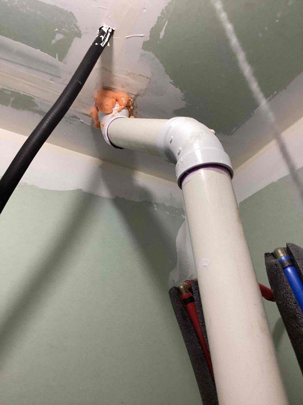 Responded to service call for leaking water heater in residential utility room. Performed comprehensive assessment of existing gray cylindrical water heater showing signs of active leakage. Documented current installation including PVC venting system with 90-degree elbow configuration, PEX manifold distribution system with separate hot and cold water lines, and existing water treatment equipment. Provided detailed estimate for complete water heater replacement to resolve leak issue and restore reliable domestic hot water service.