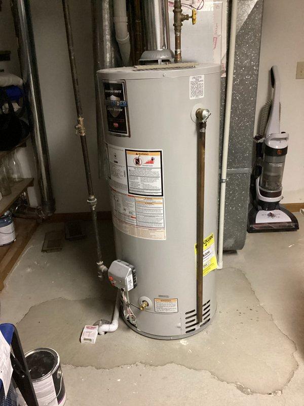 Provided estimate for replacement of existing standard atmospheric vent tank-style water heater located in basement utility area of 1980s-era condominium. Inspected current A.O. Smith unit with conventional venting configuration, copper supply plumbing, brass shutoff valves, and temperature/pressure relief valve with discharge piping. Evaluated installation space, existing venting pathway through galvanized ductwork, gas supply line accessibility, and clearance requirements for replacement unit. Documented equipment specifications, plumbing connections, and mechanical room layout through photographs. Quoted like-for-like replacement with comparable capacity atmospheric vent gas water heater suitable for residential application. Customer also expressed interest in future water softener installation estimate.