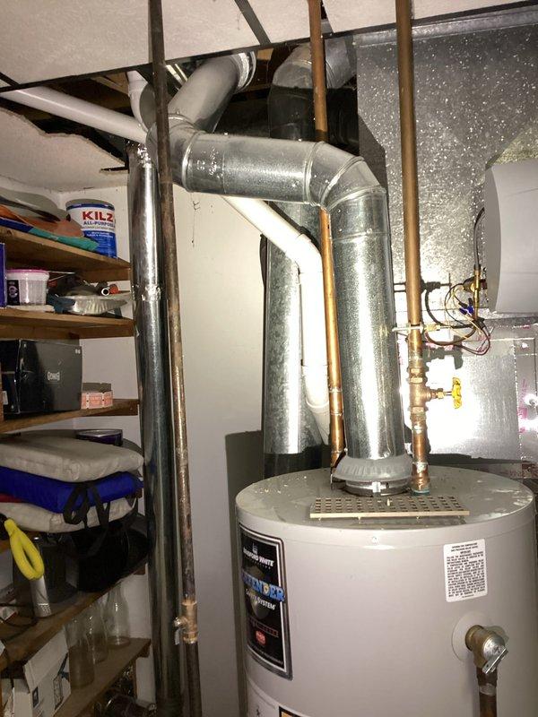 Provided estimate for replacement of existing standard atmospheric vent tank-style water heater located in basement utility area of 1980s-era condominium. Inspected current A.O. Smith unit with conventional venting configuration, copper supply plumbing, brass shutoff valves, and temperature/pressure relief valve with discharge piping. Evaluated installation space, existing venting pathway through galvanized ductwork, gas supply line accessibility, and clearance requirements for replacement unit. Documented equipment specifications, plumbing connections, and mechanical room layout through photographs. Quoted like-for-like replacement with comparable capacity atmospheric vent gas water heater suitable for residential application. Customer also expressed interest in future water softener installation estimate.