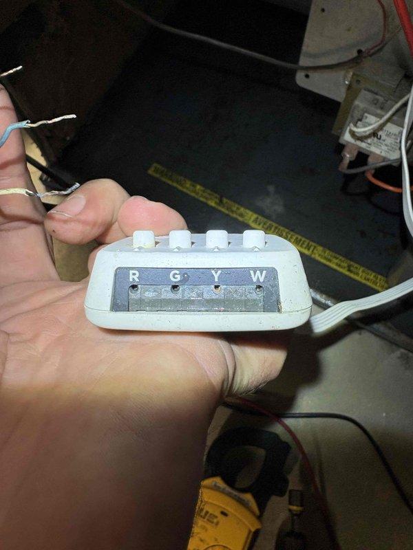 # CP-Cooling Problem Resolution

Responded to service call for 38-year-old Carrier system with no air circulation and inoperative blower fan following previous day's repair work. Upon arrival, diagnosed issue as improper thermostat wiring connection at control interface. Inspected thermostat terminal block and identified multiple loose or incorrectly landed wires on R, G, Y, and W terminals. Removed existing wire connections, verified wire integrity, stripped and prepared wire ends as needed, and properly reconnected all low-voltage control wiring according to manufacturer specifications. Confirmed proper seating of green (fan), red/pink (power), blue (common), tan (heat), and white (cooling) conductors. Restored power to system, tested thermostat functionality across all modes, and verified blower motor operation and proper air circulation throughout system. Unit now operating as designed with all functions restored.