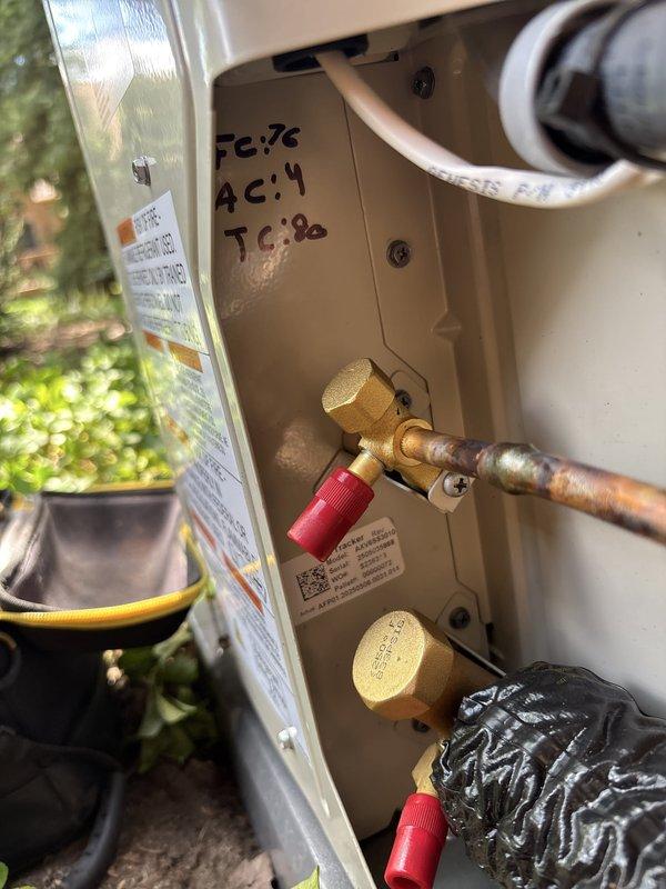 Completed full installation of residential furnace and air conditioning system. New outdoor condensing unit was positioned on concrete pad with proper refrigerant line connections utilizing black insulated piping. Indoor furnace unit was installed with all necessary electrical disconnects, copper refrigerant lines with brass fittings and service valves, and white PVC condensate drainage piping. System was charged, tested, and verified operational with diagnostic readings recorded on equipment access panel. All components properly mounted to building exterior with cedar shake siding, ensuring code-compliant installation and optimal system performance.