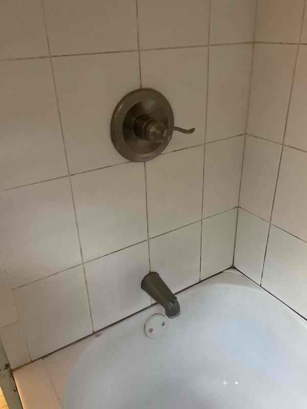 Responded to service call for leaky bathroom tub faucet. Upon inspection, identified worn internal components in the shower valve assembly causing water seepage at the tub spout. Disassembled the single-lever shower valve control with bronze finish, replaced deteriorated cartridge and O-rings, and reassembled unit. Tested for proper operation and verified leak was eliminated. All fixtures restored to full working condition.