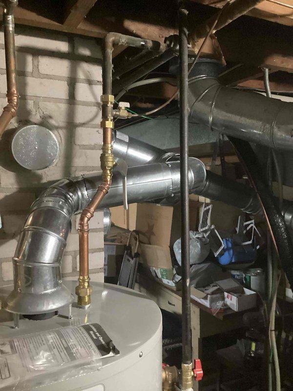 Responded to inspector correction for improperly sized chimney liner installation. Removed existing 4-inch liner and installed new 5-inch chimney liner to accommodate both water heater and furnace venting requirements per code. Replaced defective gas shut-off valve and coupler on water heater to ensure proper safety compliance. All venting connections secured and tested for proper draft and combustion safety.