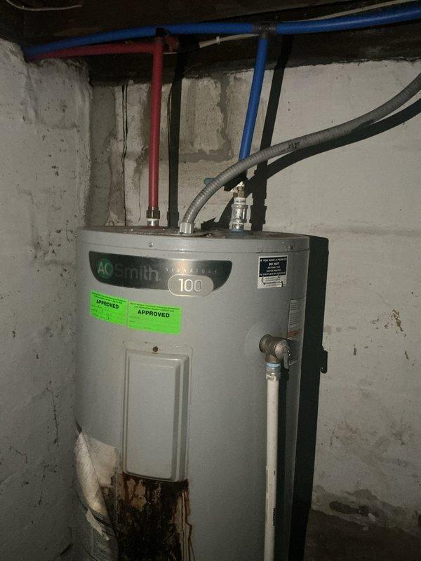 Performed comprehensive plumbing inspection for pre-sale home evaluation. Inspected all accessible plumbing systems and fixtures throughout property to verify proper operation and identify any issues requiring attention before listing.

During inspection, discovered A.O. Smith 100-gallon water heater with significant rust and corrosion damage at base of tank, indicating potential tank failure and active deterioration. Dark brown to orange discoloration and staining extended vertically from floor level upward on lower front section of unit. Documented condition with photographs showing extent of corrosion damage and overall water heater installation. Inspected all water supply connections, piping, and shutoff valves at top of unit. Verified proper venting and electrical connections to water heater.

Advised that water heater exhibits signs of advanced deterioration requiring replacement prior to sale to avoid complications during home inspection process. Provided documentation of findin