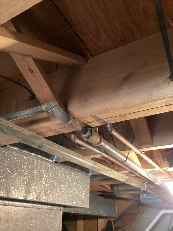 Conducted site assessment for tankless water heater installation in 1967-constructed residence. Evaluated existing plumbing infrastructure, including exposed pipe routing through attic space and utility area mechanical systems. Documented current HVAC equipment placement, ductwork configuration, and available utility connections to determine optimal location and requirements for on-demand water heater installation.