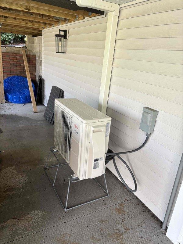 Completed annual cooling maintenance on EnergiAir ductless mini-split system (model year 2021, warranty through June 2032). Inspected outdoor condenser unit positioned on elevated stand on covered patio and indoor wall-mounted air handler. Performed standard tune-up procedures including cleaning coils, checking refrigerant levels, testing electrical connections at disconnect box, verifying proper drainage, and confirming operational performance of both indoor and outdoor units.