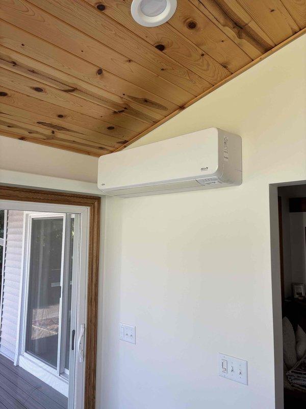 Completed annual cooling maintenance on EnergiAir ductless mini-split system (model year 2021, warranty through June 2032). Inspected outdoor condenser unit positioned on elevated stand on covered patio and indoor wall-mounted air handler. Performed standard tune-up procedures including cleaning coils, checking refrigerant levels, testing electrical connections at disconnect box, verifying proper drainage, and confirming operational performance of both indoor and outdoor units.