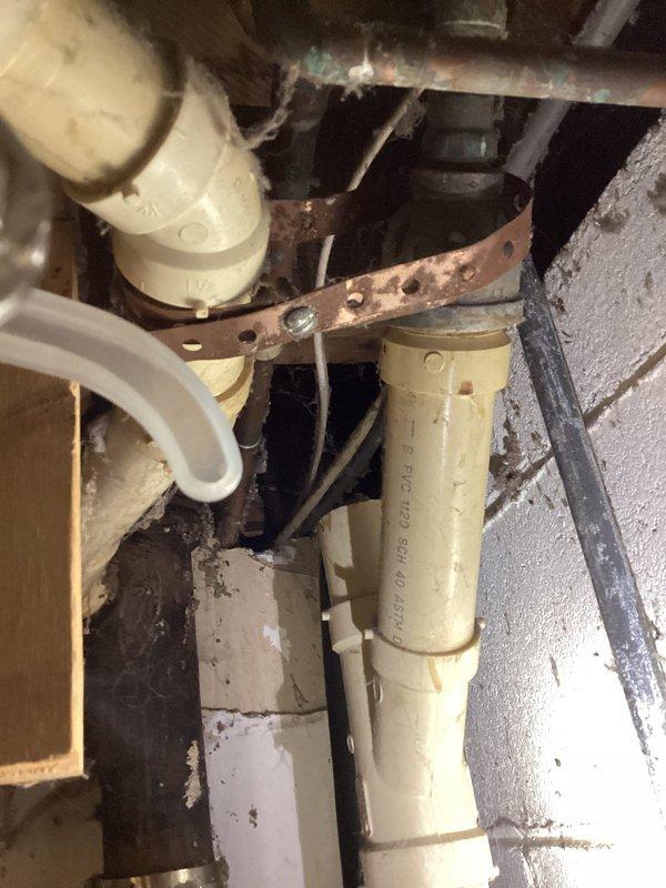 Responded to a bathroom sink drain clog causing extremely slow drainage. Accessed plumbing system through crawl space and inspected the drainage assembly, including PVC piping configuration and associated mechanical components. Successfully cleared the obstruction and restored proper drainage flow to the fixture.