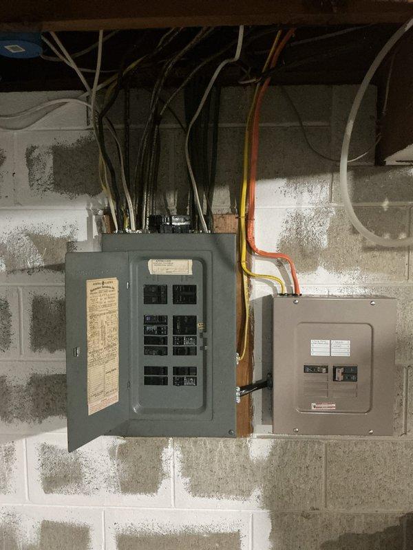 Conducted electrical assessment of 1960s-era residential service panel for kitchen circuit overload issue. Multiple kitchen outlets currently share a single circuit, causing breaker trips when operating multiple appliances simultaneously. Evaluated existing electrical panel configuration, circuit loading, and available capacity to determine feasibility of circuit separation. Documented current electrical infrastructure including main panel and subpanel arrangement mounted on basement concrete block wall. Provided estimate for installing dedicated circuits to distribute kitchen outlet loads across separate breakers, ensuring adequate amperage for simultaneous appliance operation and eliminating nuisance tripping.
