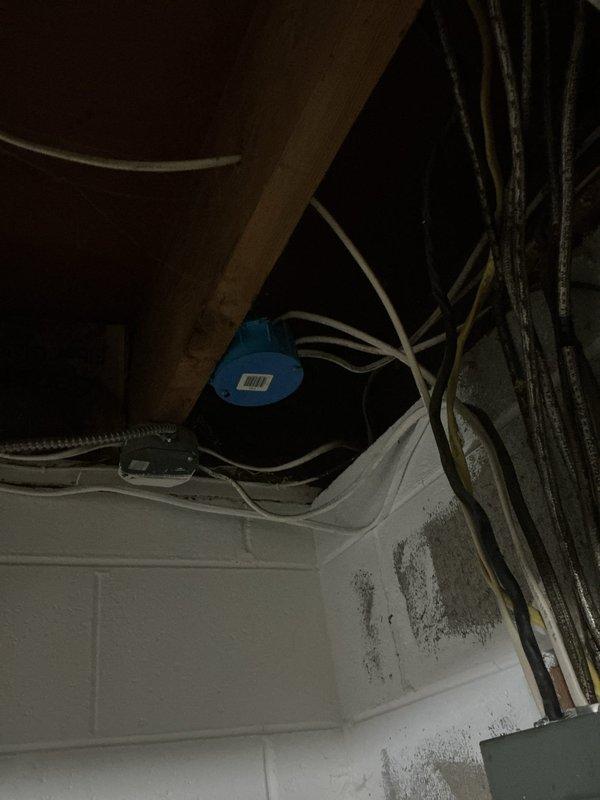 Conducted electrical assessment of 1960s-era residential service panel for kitchen circuit overload issue. Multiple kitchen outlets currently share a single circuit, causing breaker trips when operating multiple appliances simultaneously. Evaluated existing electrical panel configuration, circuit loading, and available capacity to determine feasibility of circuit separation. Documented current electrical infrastructure including main panel and subpanel arrangement mounted on basement concrete block wall. Provided estimate for installing dedicated circuits to distribute kitchen outlet loads across separate breakers, ensuring adequate amperage for simultaneous appliance operation and eliminating nuisance tripping.