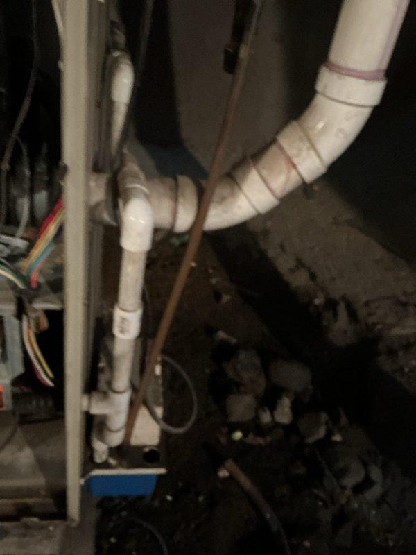 Completed annual cooling maintenance on 21-year-old Bryant air conditioning system. Performed comprehensive tune-up including inspection of outdoor condenser unit where damaged grille section with tape repair was documented, condenser coils assessed and found in acceptable condition, and interior components including refrigerant lines, PVC drainage system, and electrical connections were inspected and verified operational.