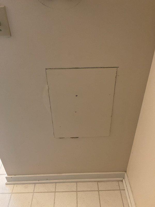 Completed bathroom drywall access panel repairs including removal of damaged section, preparation of opening, and installation of new access panel with proper finishing. Replaced worn drywall material and ensured flush mounting with existing wall surface for seamless integration with surrounding tile work.