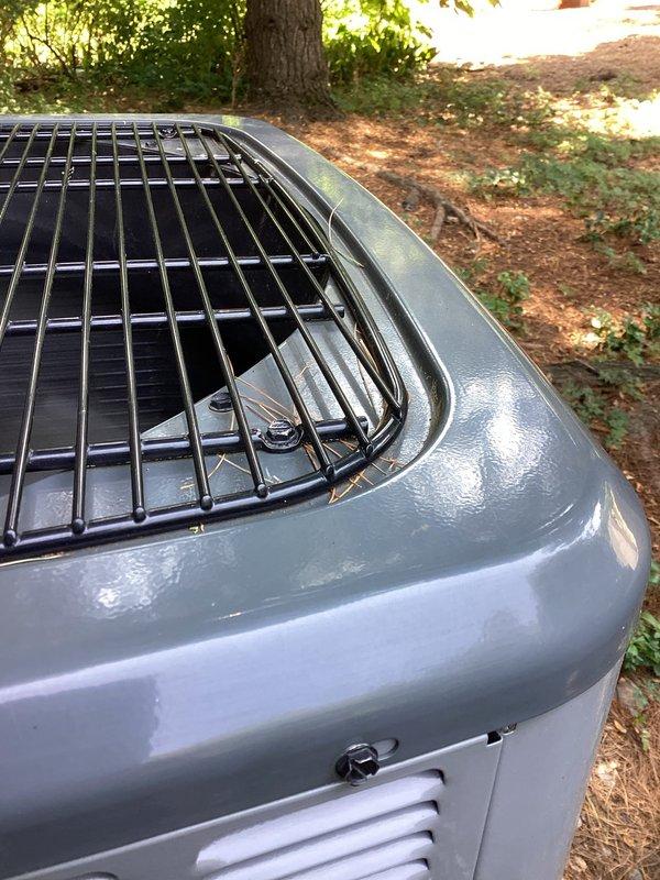 Responded to noise complaint regarding rattling outdoor condenser unit. Inspected and tightened all mounting screws securing the top protective fan grille to the unit housing, which had worked loose and were causing vibration noise during operation. Verified grille is now properly seated and secured, eliminating the rattling issue.